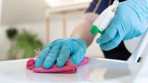 Cleaning professionals disinfecting residential countertops.